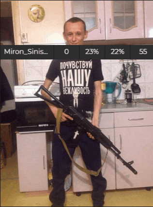 a man holding a gun in a kitchen wearing a shirt that says " miron_sinis "