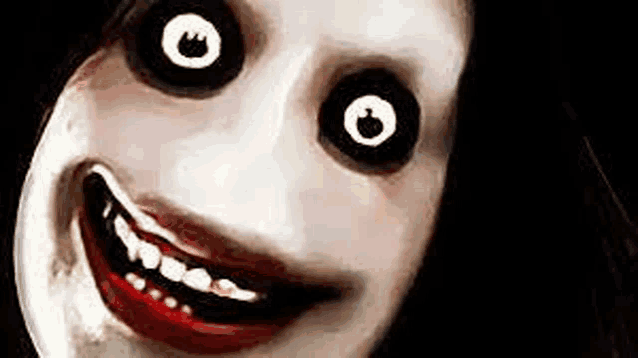 a close up of a scary woman 's face with big black eyes and red teeth .