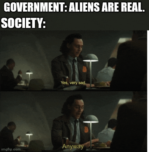 a man is sitting at a table with a lamp and a caption that says government aliens are real society