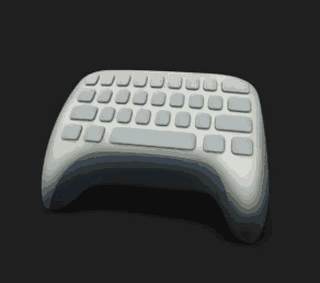 a remote control with a keyboard on it is sitting on a black surface