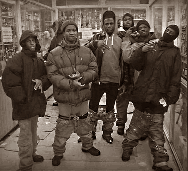 a black and white photo of a group of young men posing for a photo