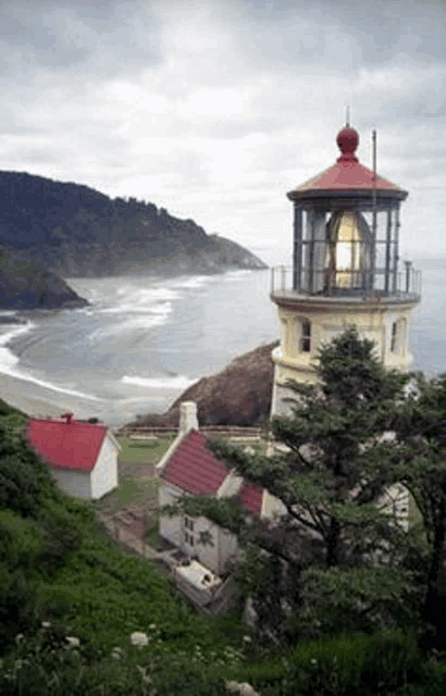 a lighthouse sits on top of a cliff overlooking the ocean