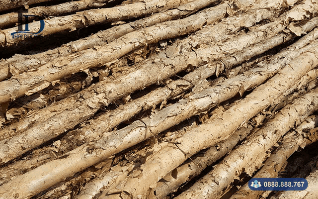 a bunch of logs are stacked on top of each other with a phone number underneath