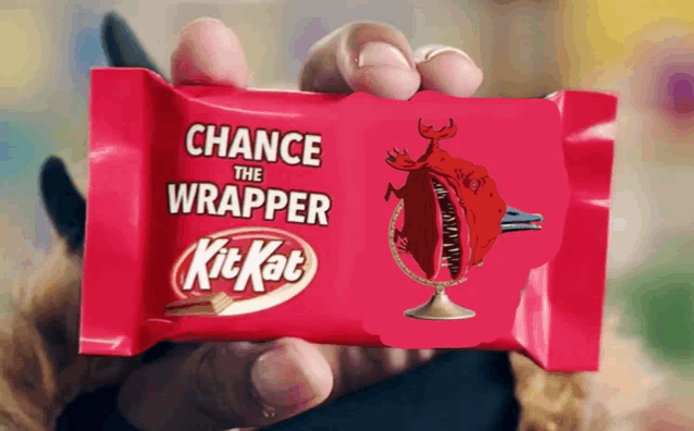 a person is holding a pink kitkat bar with a picture of a dragon on it