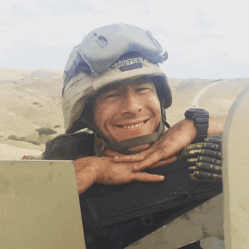 a smiling soldier wearing a helmet that says copter