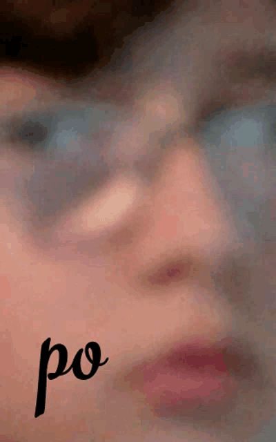 a blurred image of a person 's face with the word po written below it