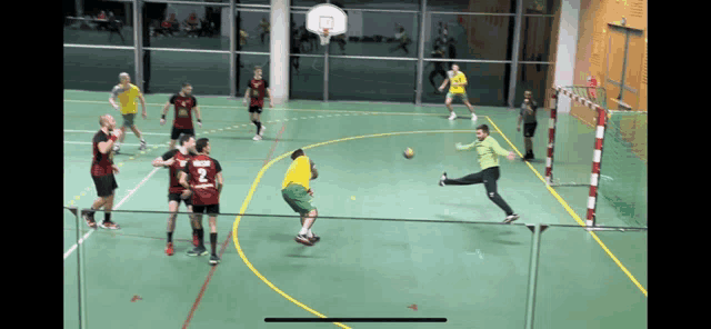 a group of men are playing a game of handball and one of the players has the number 3 on his back