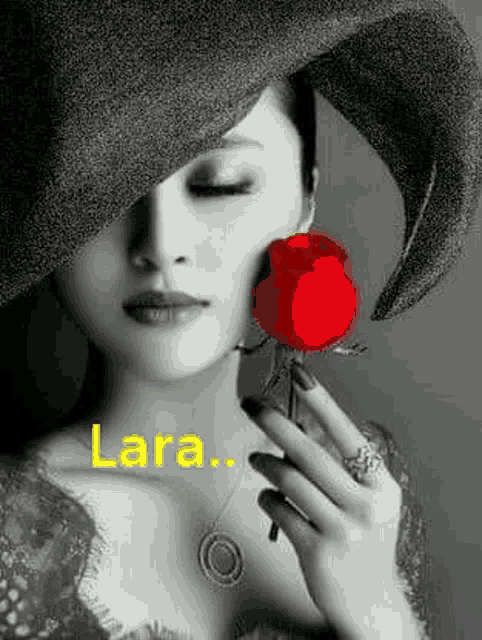 a woman wearing a hat is holding a red rose in her hand .