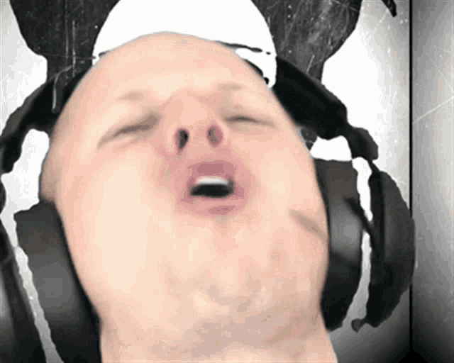 a man wearing headphones making a face with his mouth open