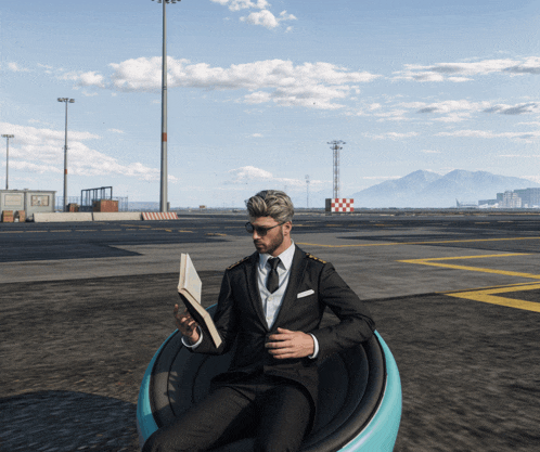 a man in a suit is reading a book while sitting in a chair