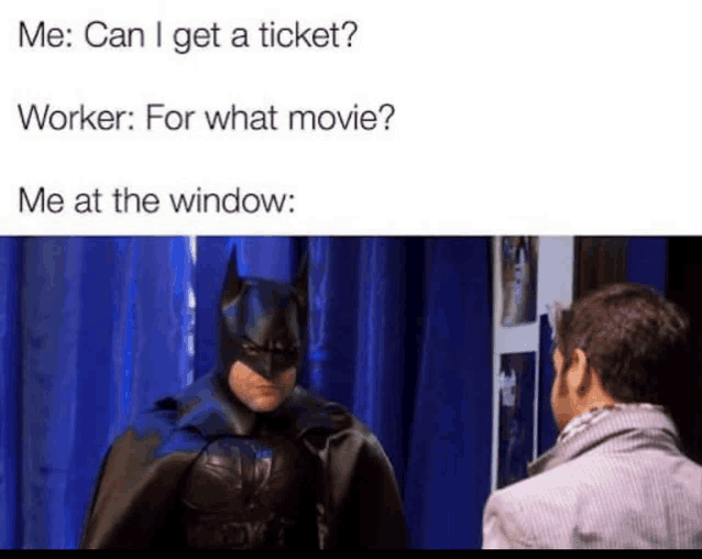 a man in a batman costume is talking to another man in a window .