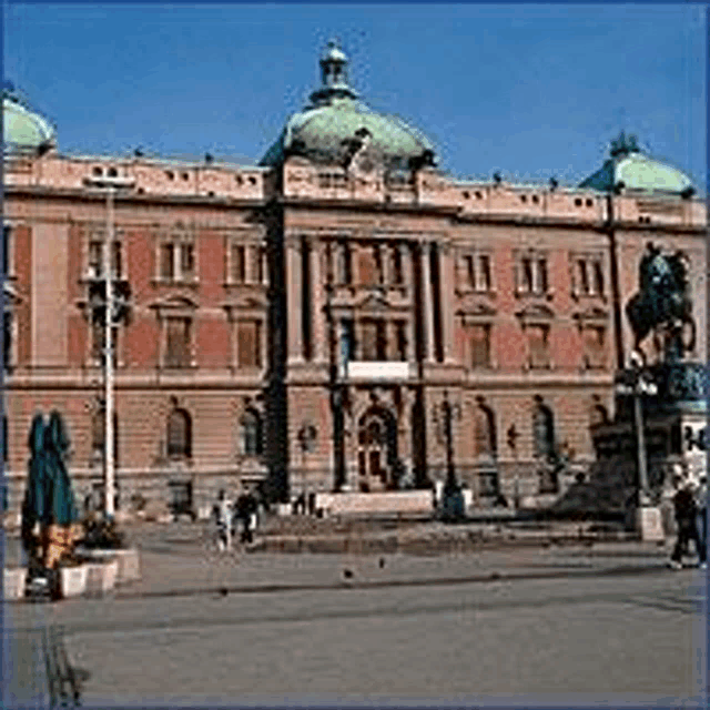 a large building with a statue of a horse in front of it