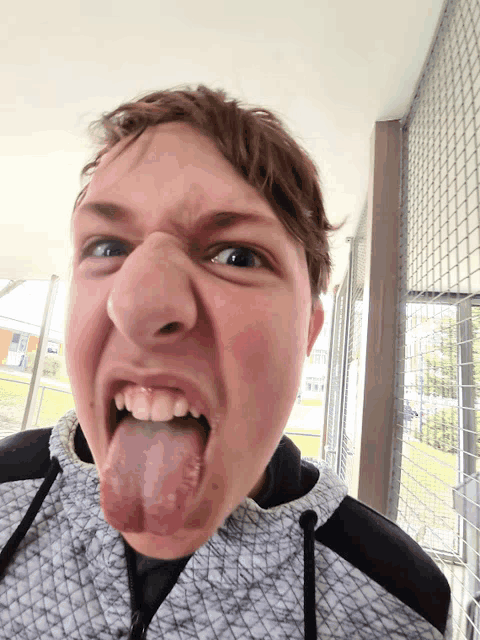 a young man making a face with his tongue out