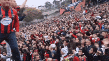 a crowd of people in a stadium with a man wearing a shirt that says ' allianz ' on it