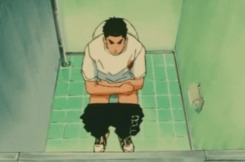 a man sits on a toilet with his pants down