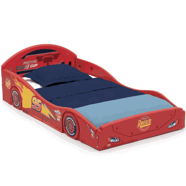 a red piston cup car bed with a blue comforter