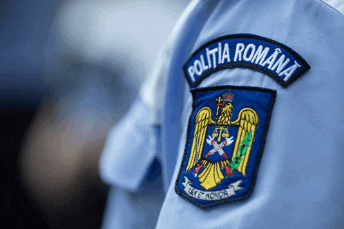 a blue patch on a person 's shirt says politia romana