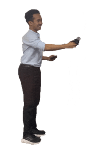 a man in a blue shirt and black pants holds a remote control