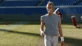 a man is walking on a tennis court with a tennis racket .