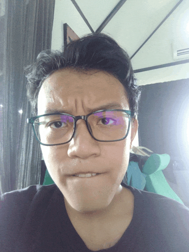 a man wearing glasses makes a funny face