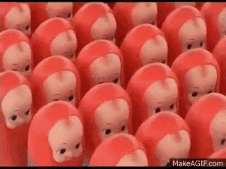 a bunch of red monkey dolls are standing next to each other .