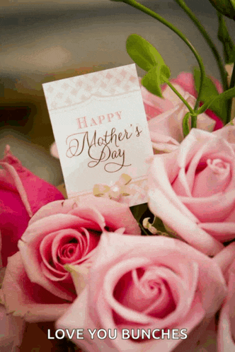 a bouquet of pink roses with a card that says happy mothers day