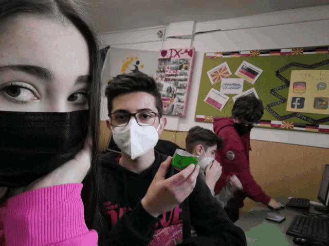 a group of young people wearing face masks in front of a bulletin board that says ' bulgaria ' on it