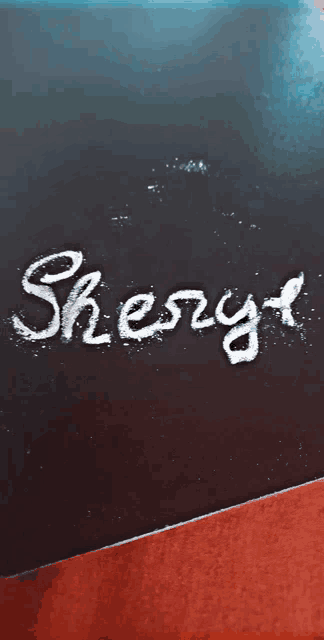 the word sherry is written in white chalk on a black board