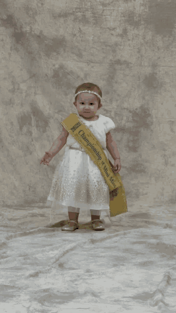 a little girl in a white dress is wearing a sash that says championship of miss texas