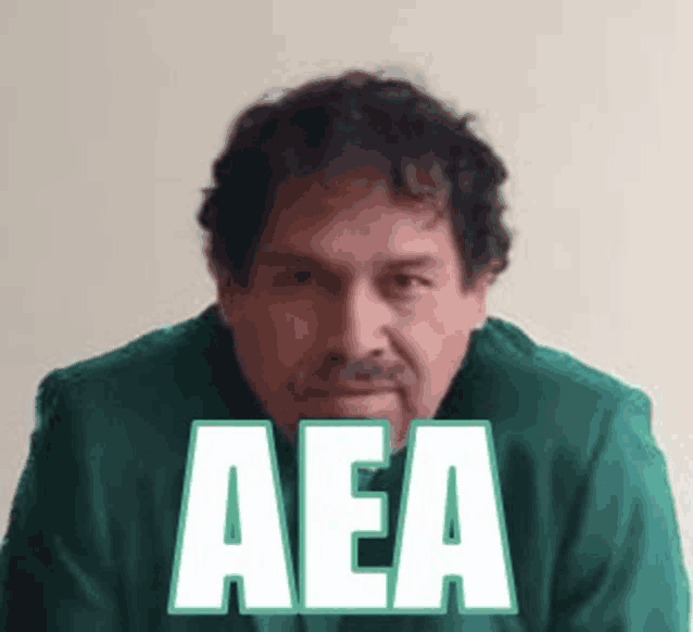 a man in a green shirt with the word aea written on it .