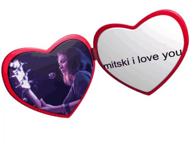 a heart shaped mirror with a picture of a woman playing a guitar and the words mitski i love you