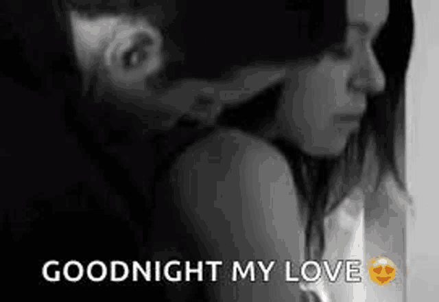 a man is kissing a woman on the neck in a black and white photo with the words `` goodnight my love '' .