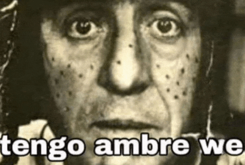 a black and white photo of a man 's face with the words `` tengo ambre we '' written above it .