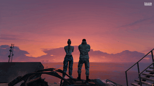 a man and a woman in military uniforms are looking out over a body of water