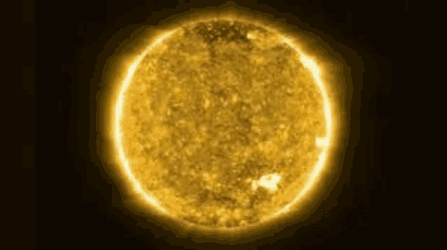 a close up of the sun on a dark background .