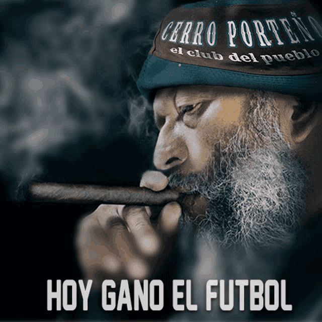 a man with a beard is smoking a cigar with the words hoy gano el futbol below him