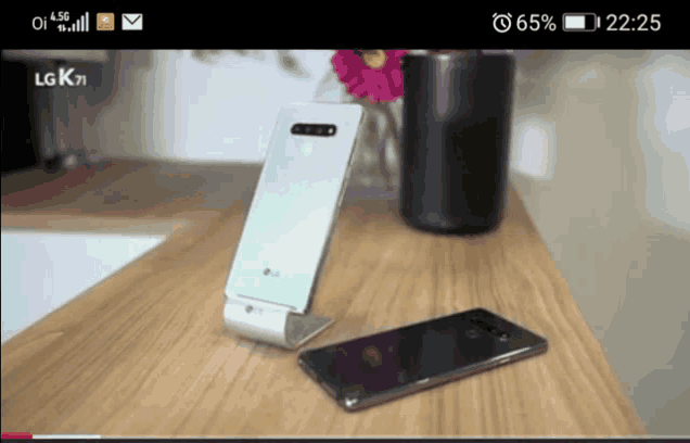 an lg phone is sitting on a wooden desk