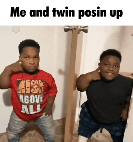 two boys standing next to each other with one wearing a red shirt that says rise above all