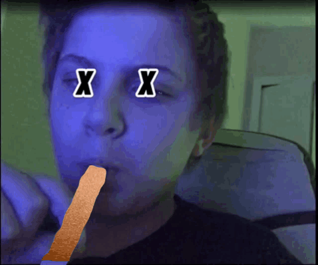 a person with two x 's on their eyes is eating a french fry