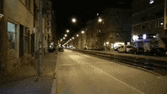 a blurred image of a city street at night with a lot of lights on .