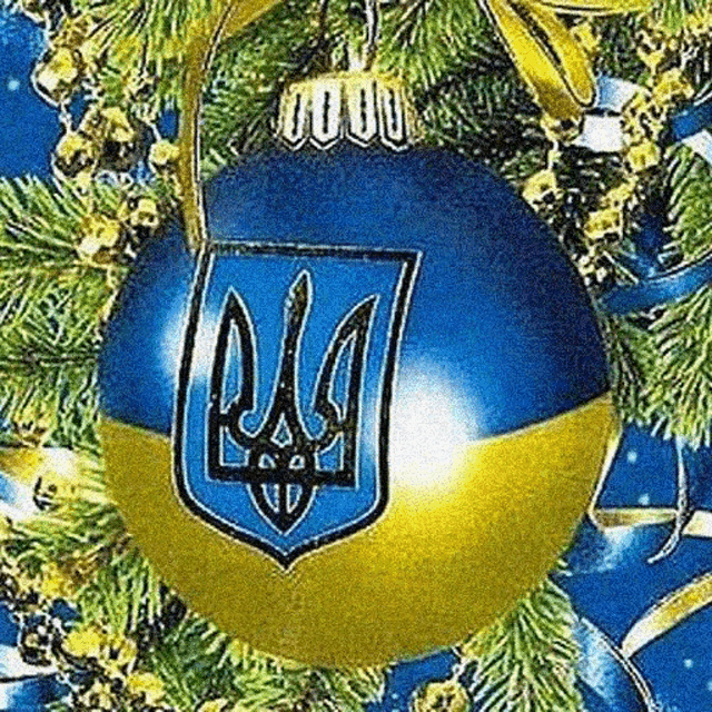 a blue and yellow christmas ball with a coat of arms on it