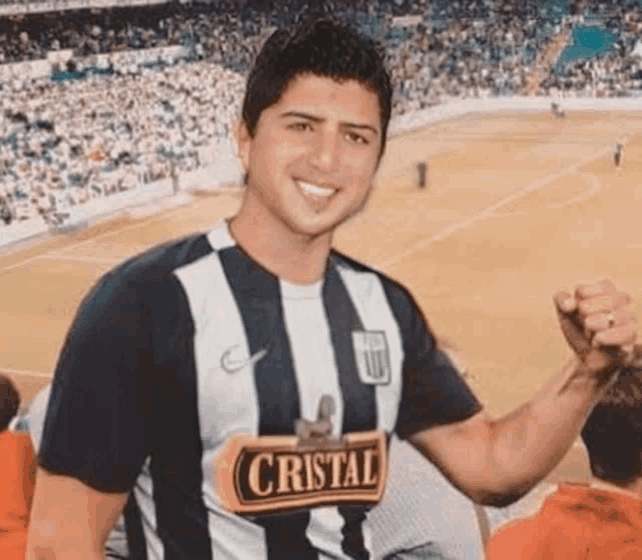 a man wearing a striped shirt that says cristal on it