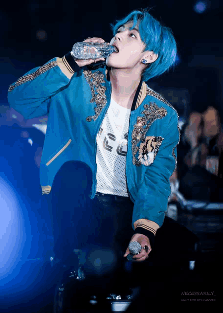 a person with blue hair drinking from a bottle