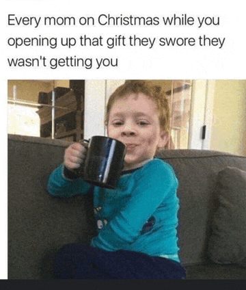 a little boy is sitting on a couch holding a mug and making a funny face .