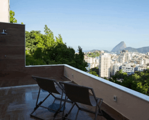 a balcony with a view of a city and mountains