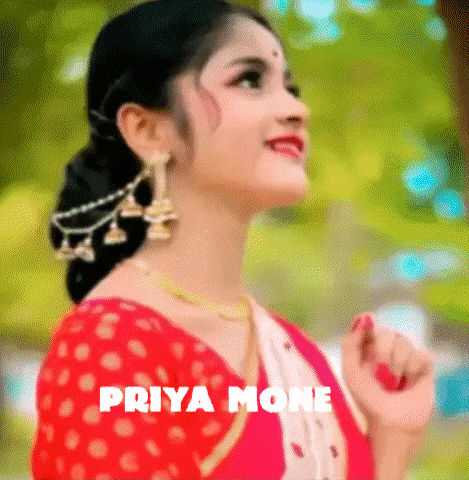 a woman in a red and white dress with the name priya mone on the bottom right