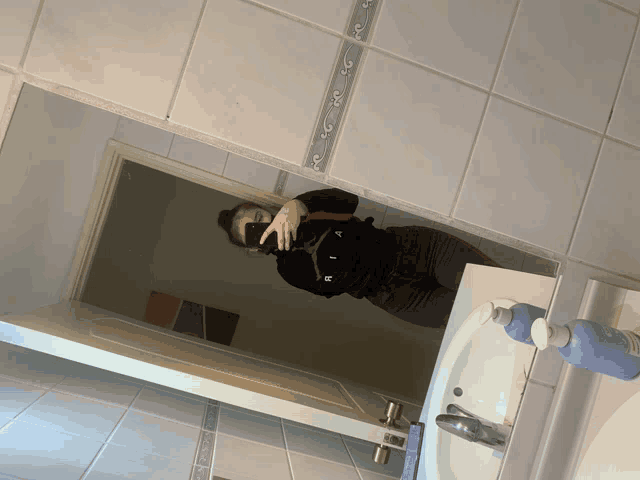 a woman taking a picture of herself in a bathroom