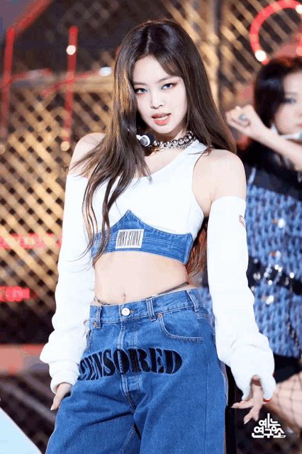 a woman in a crop top and jeans with the word censored on the bottom