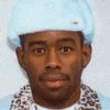 a close up of a man wearing a blue hat and a leopard print scarf .