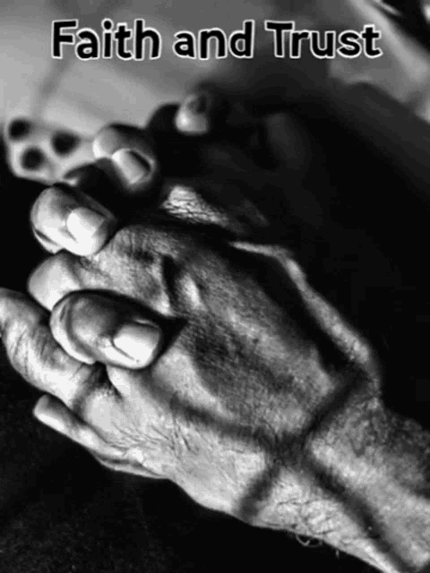 a black and white photo of a person 's hands with the words " faith and trust " on the bottom